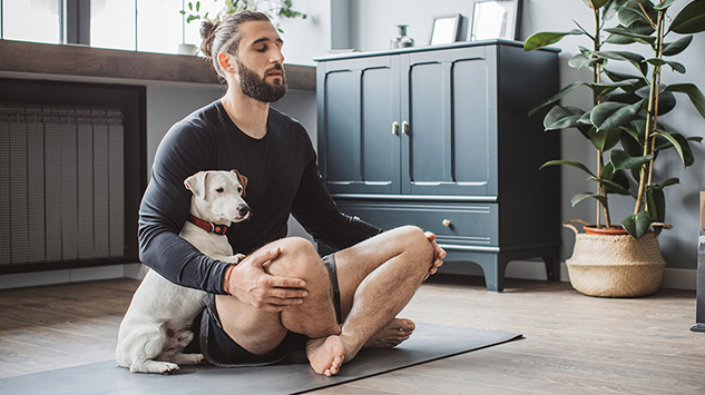 man practicing yoga at home