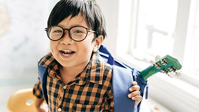 young boy with glasses smiling